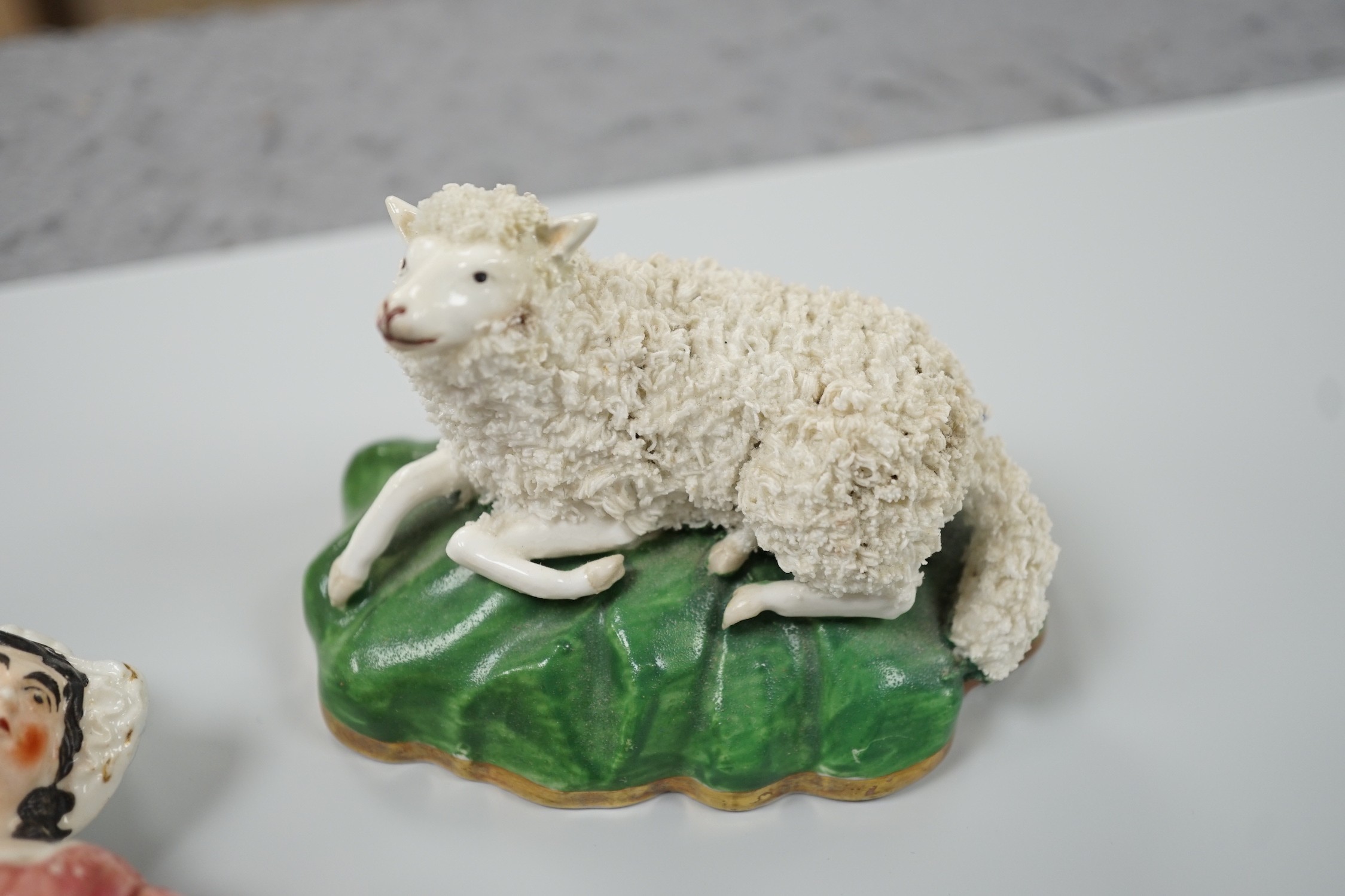 Three small Staffordshire models of recumbent sheep on oval mounted bases, together with a Staffordshire model group of a shepherdess, c.1830-50, (4). Tallest 17.5cm, Provence: Dennis G.Rice collection
